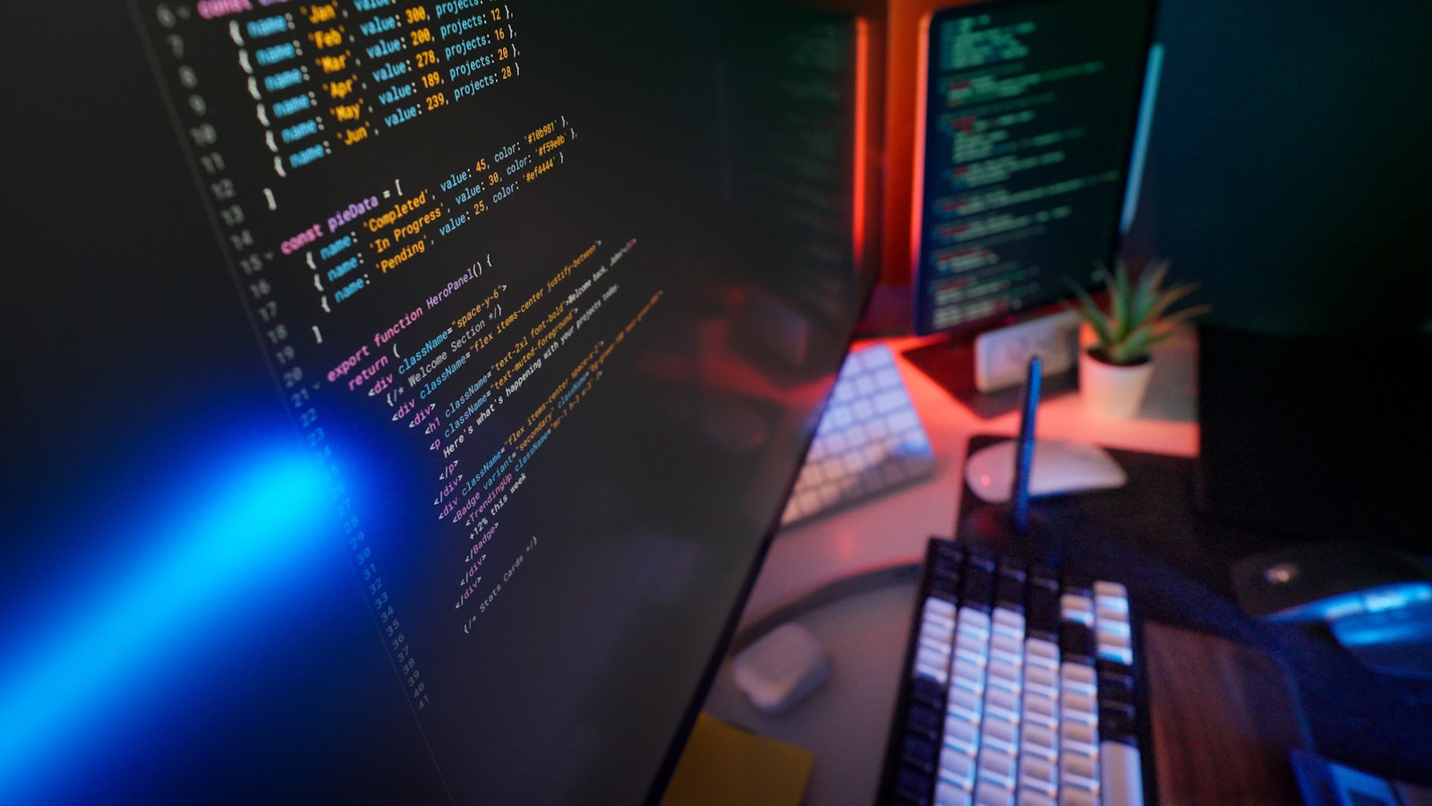 Developer workspace with code and automation dashboard on a laptop