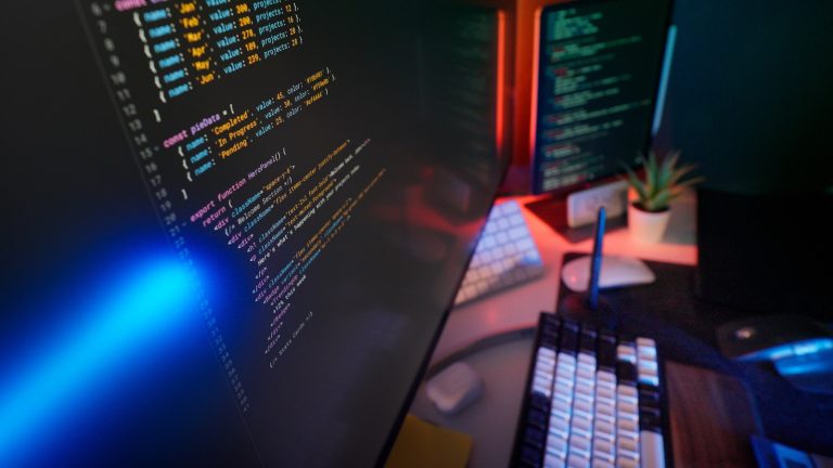 Developer workspace with code on screen and modern infrastructure feel