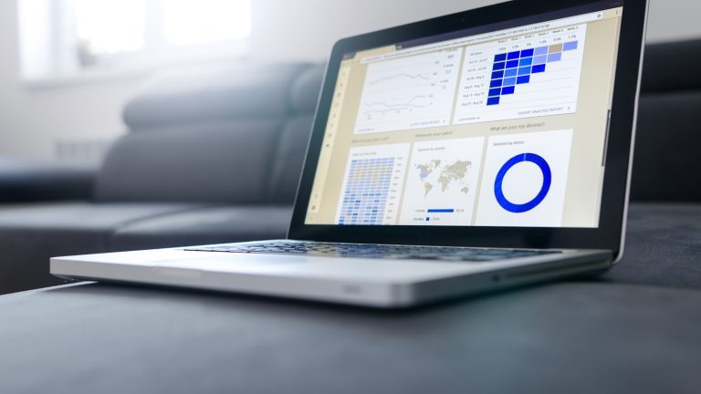 Developer reviewing a WordPress conversion and automation dashboard on a laptop