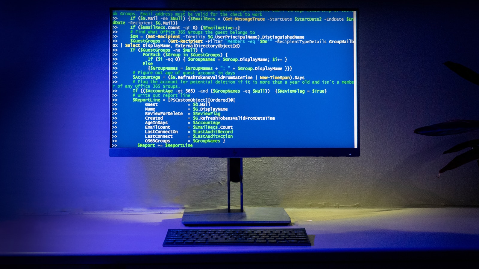 Premium workspace with laptop showing code on a clean desk