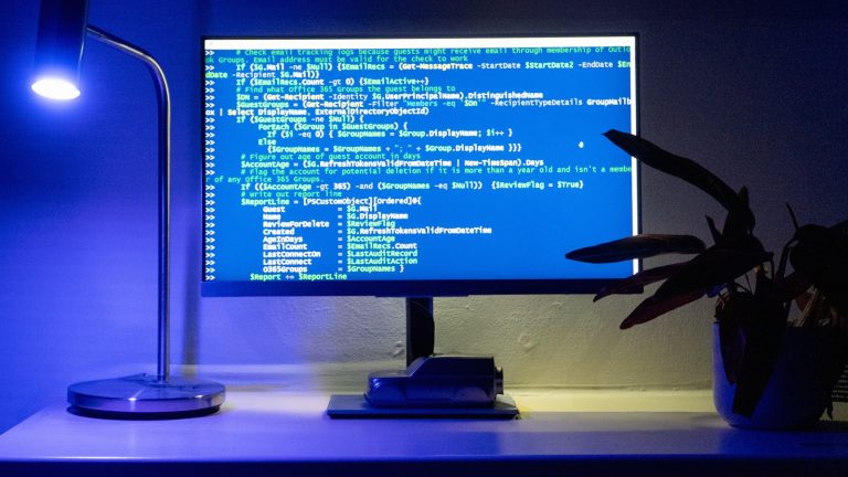 Developer planning a WordPress redesign with wireframes and analytics on a laptop
