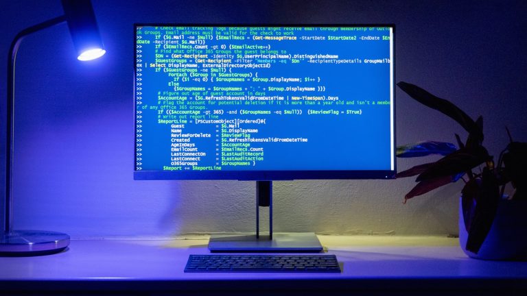 A developer's workspace showing code on multiple screens.